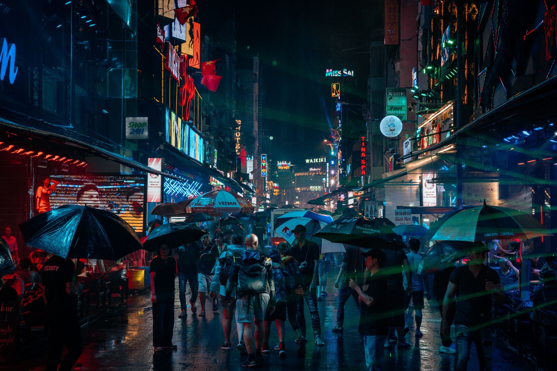 pedestrians umbrella rainy ho chi minh city street