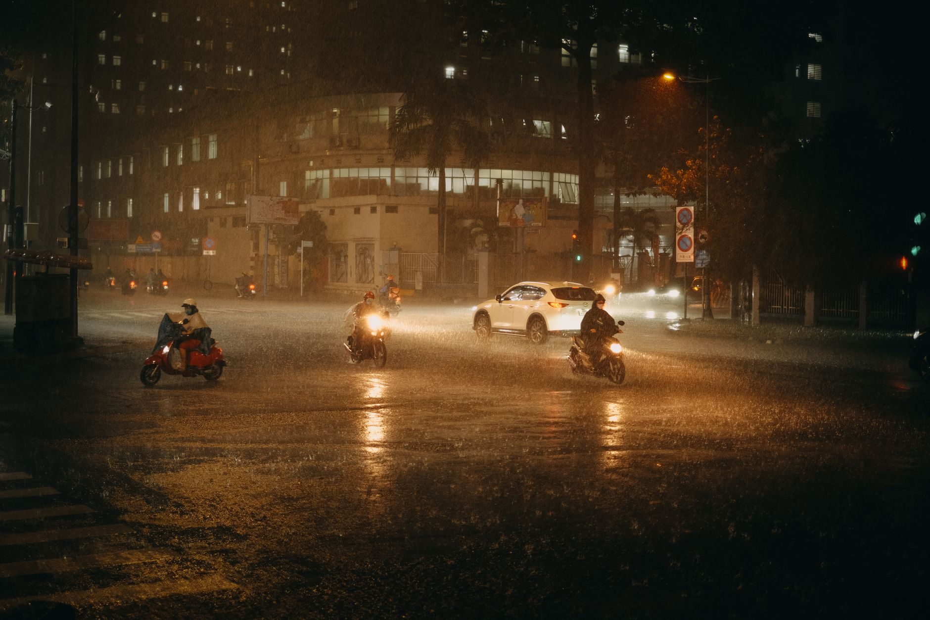 hanoi motorbike traffic evening rain